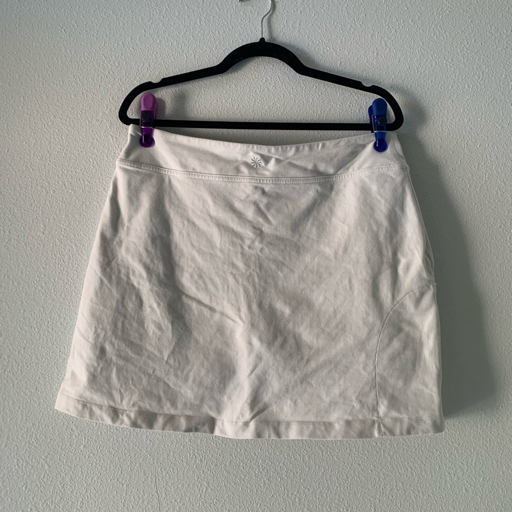 Athleta White Mini Skirt with Subtle Sunburst Logo